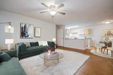 a living room with a couch and a ceiling fan